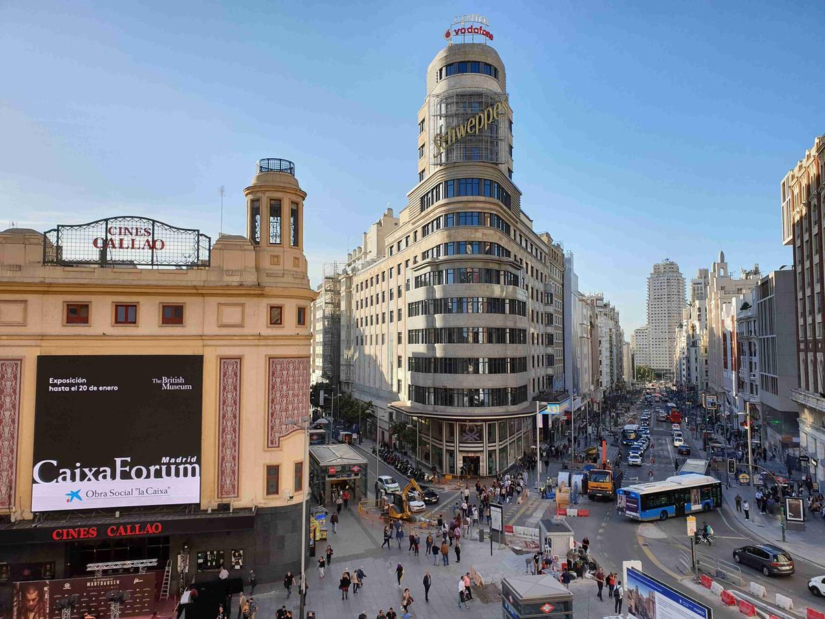 Gran Vía street view with Cines Callao and Schweppes sign in Madrid.