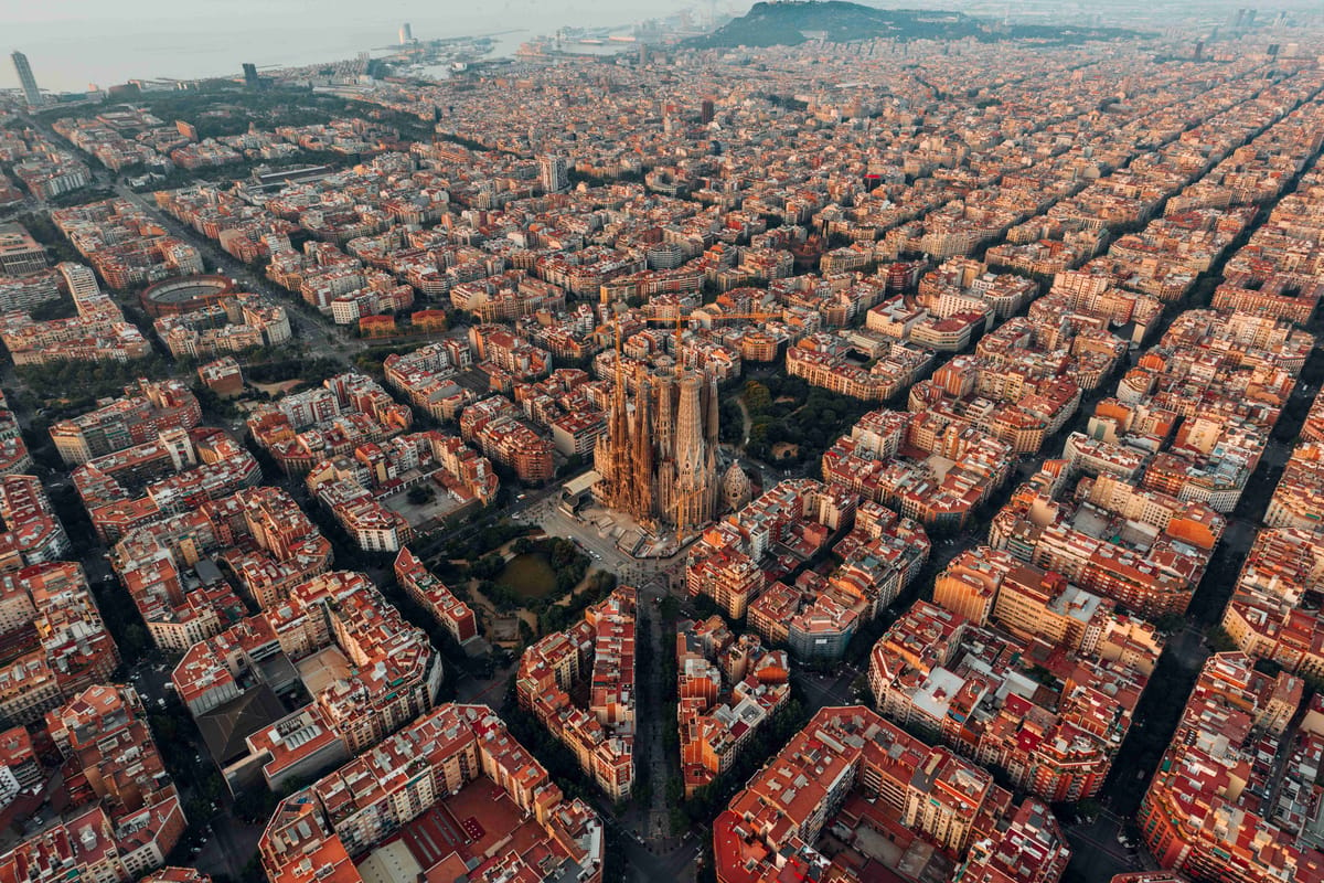 Aerial shot of Sagrada Familia surrounded by Barcelona grid.