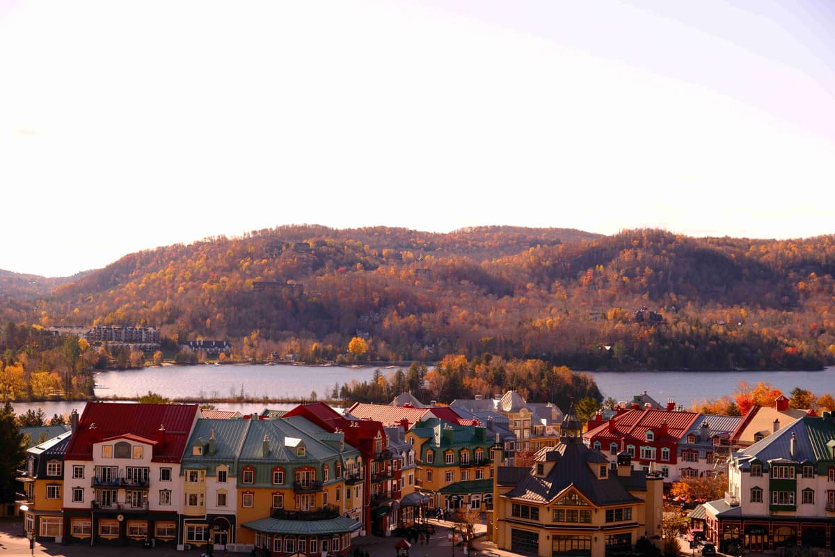 Autumn Town by the Lake with Colorful Buildings and Mountain Backdrop