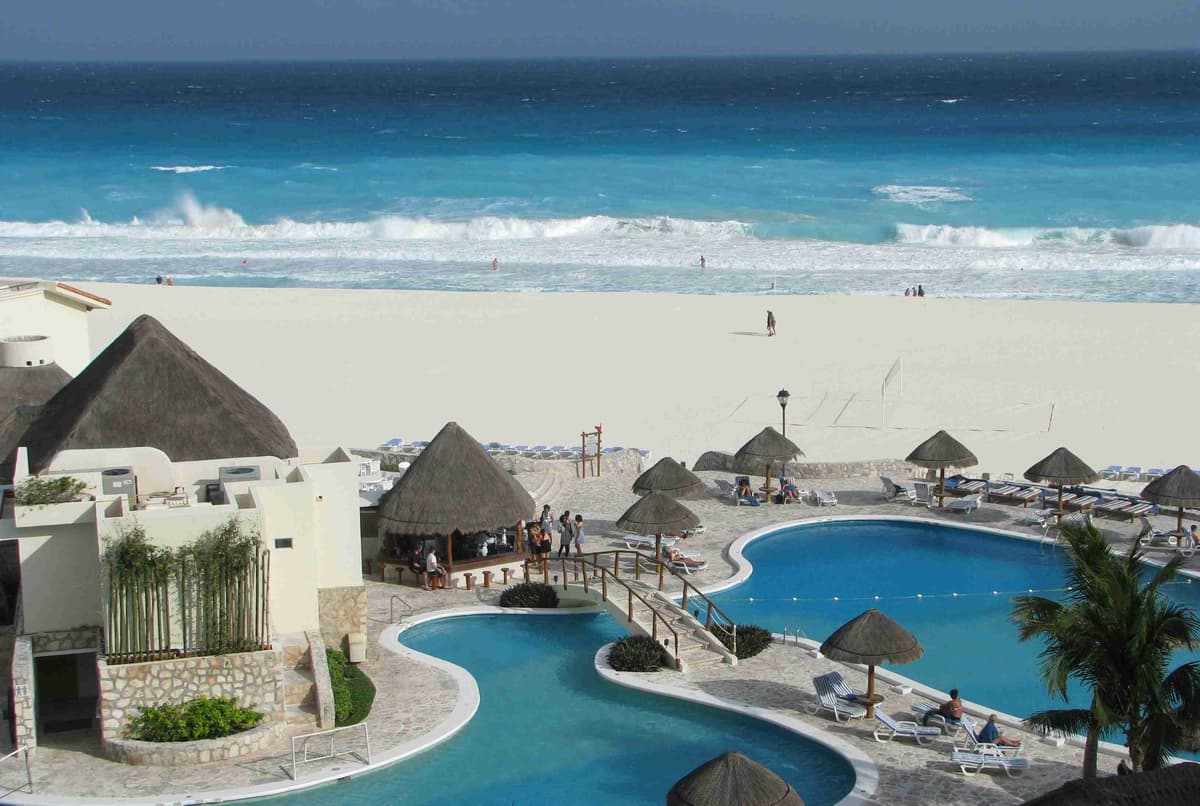 Пляжный курорт с бассейном и соломенными зонтиками