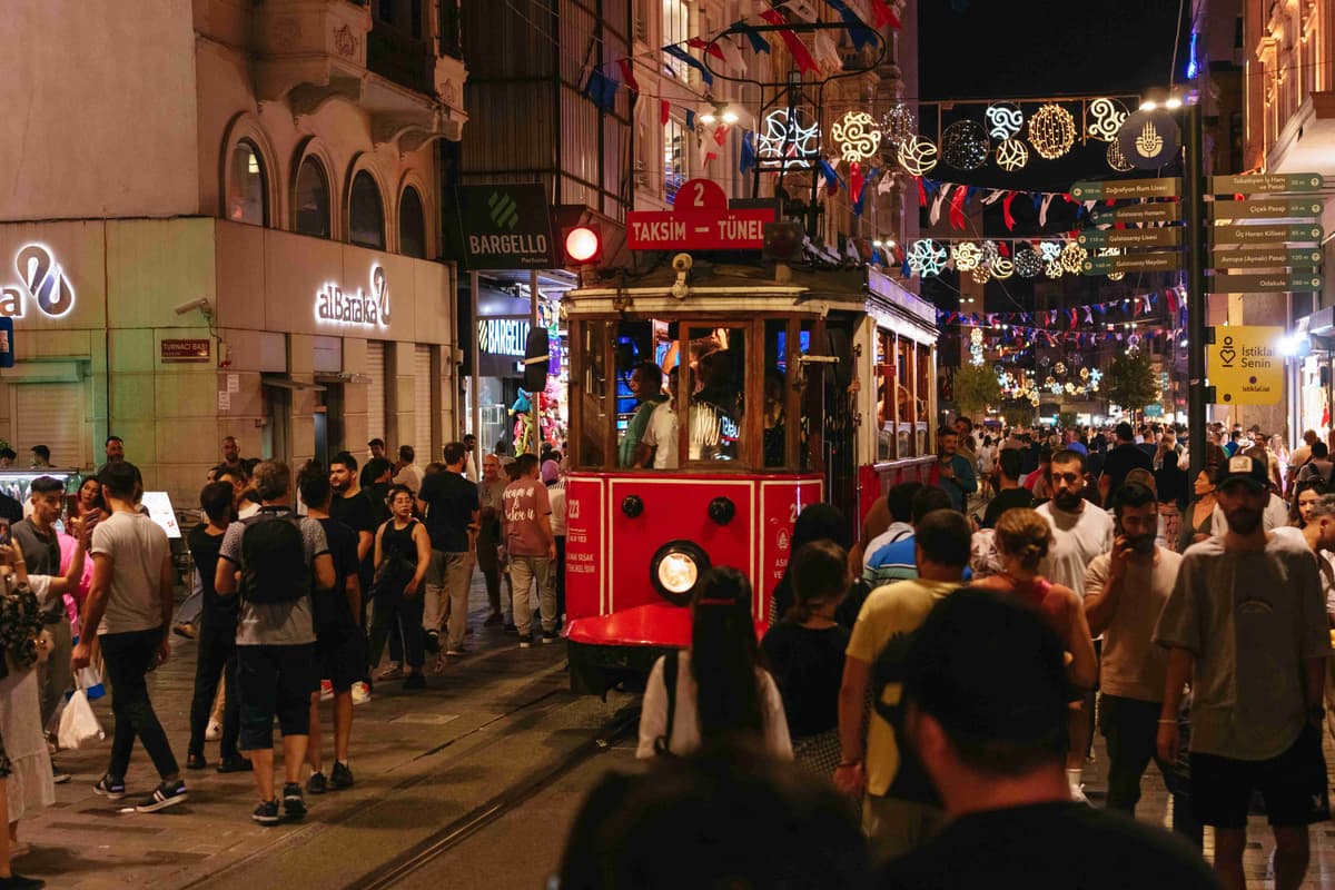 Bustling Nighttime Street with Historic Tram