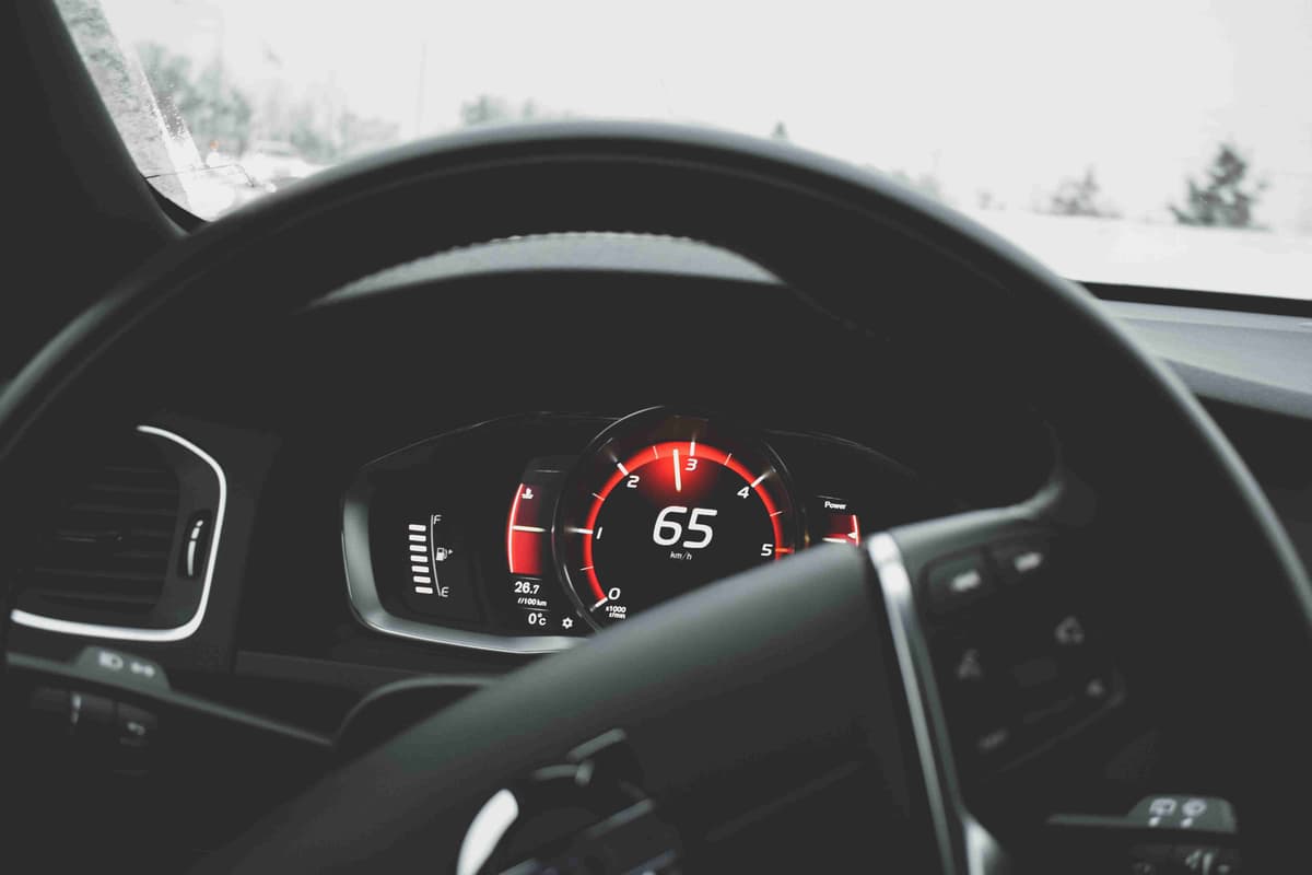 Car Speedometer at 65 MPH on Winter Road