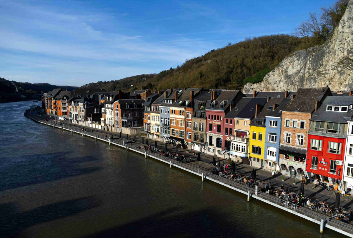 Colorful Riverside Houses with Cliff Backdrop