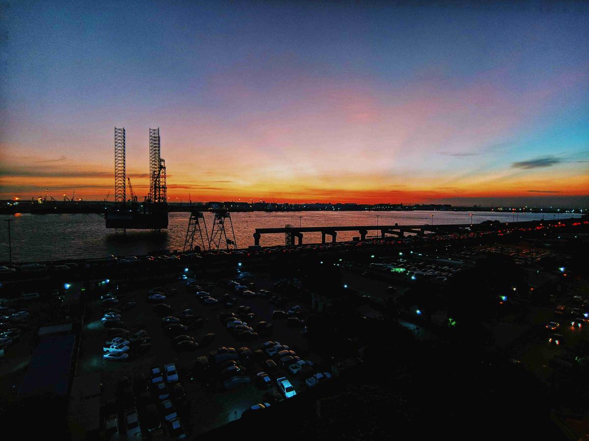 Harbor Sunset Overlook with Parking Lot and Oil Rigs