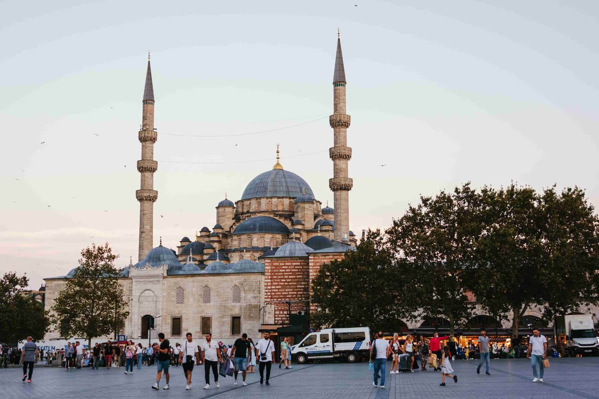 Historic Mosque Plaza at Dusk with Pedestrians