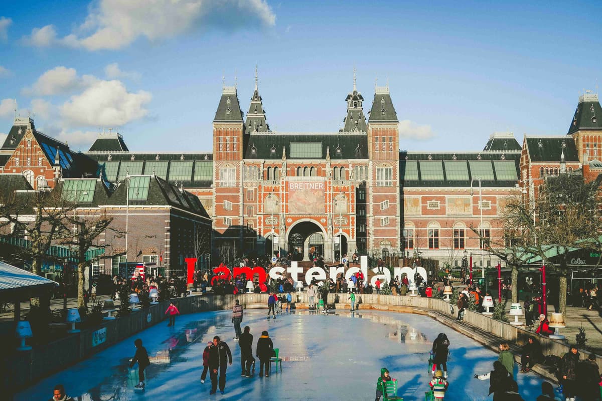 Ice Skating at Rink in Front of Rijksmuseum with Iamsterdam Sign