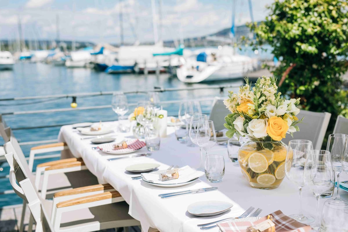 Lakeside Dining Setup with View of Sailboats