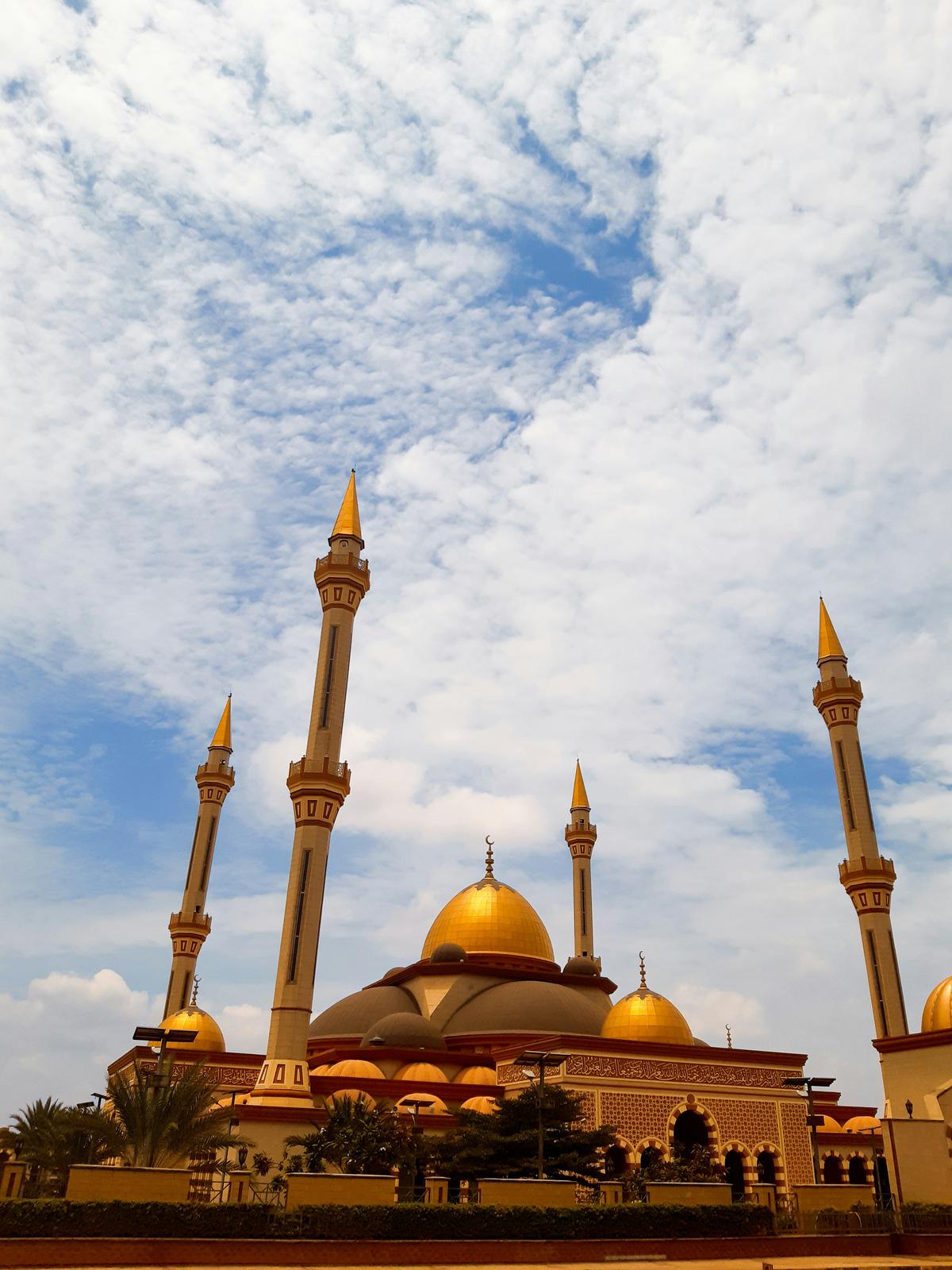 Majestic Mosque with Golden Domes Under Blue Sky