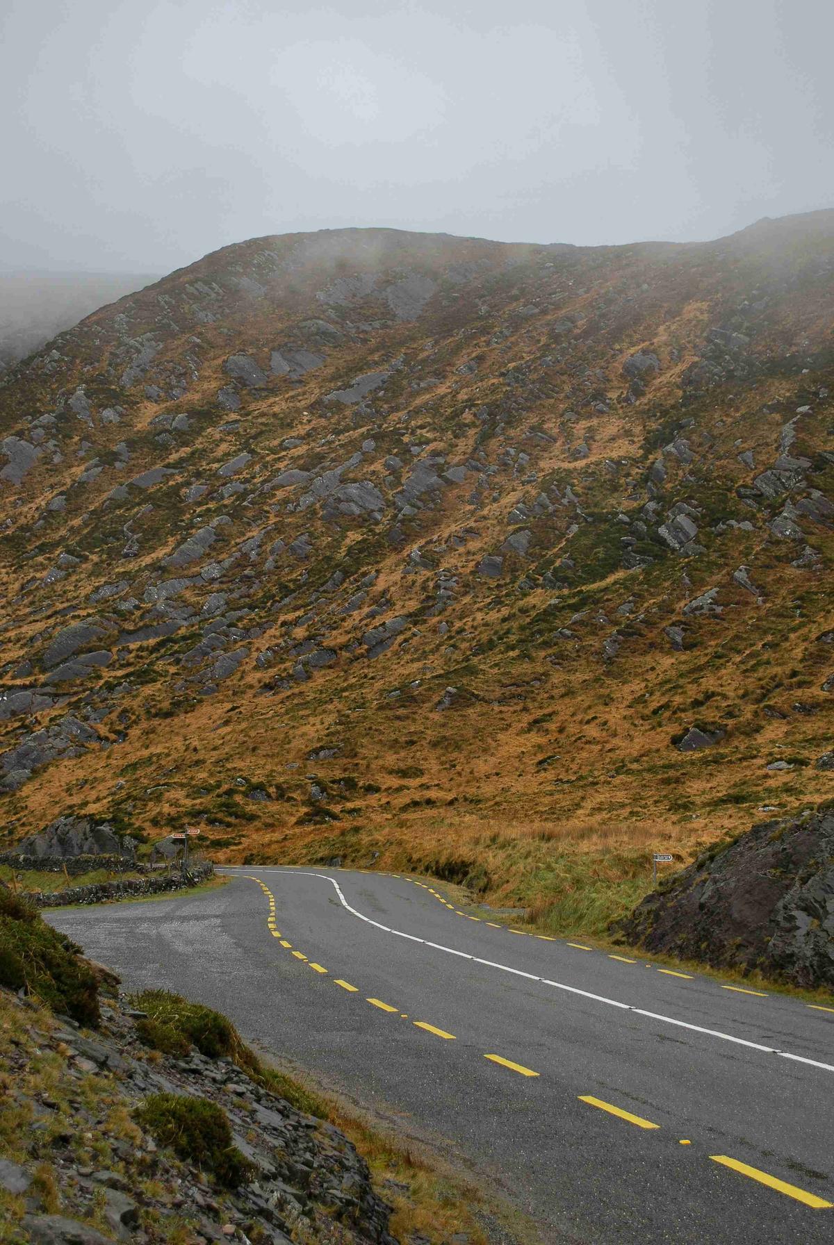 Misty Mountain Road with Yellow Dash Lines