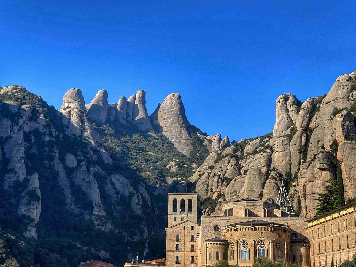 Monastery Against Mountain Peaks Under Blue Sky