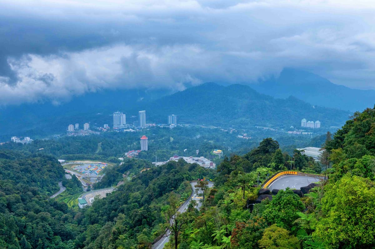 Mountainous Landscape with City View and Overcast Sky