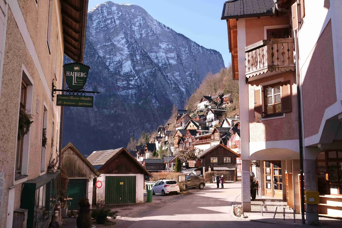 Quaint Mountain Village Street with Majestic Alps_Background