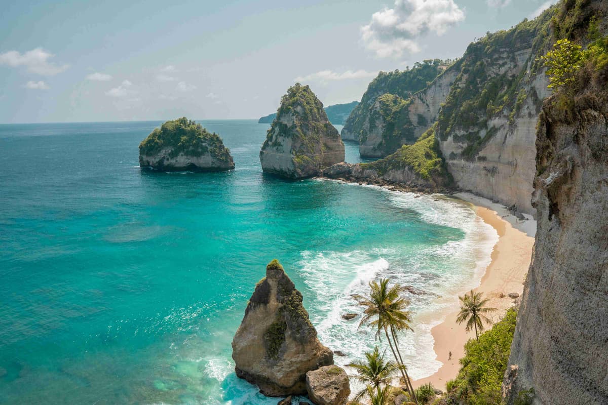 Secluded Tropical Beach with Cliffs and Turquoise Waters