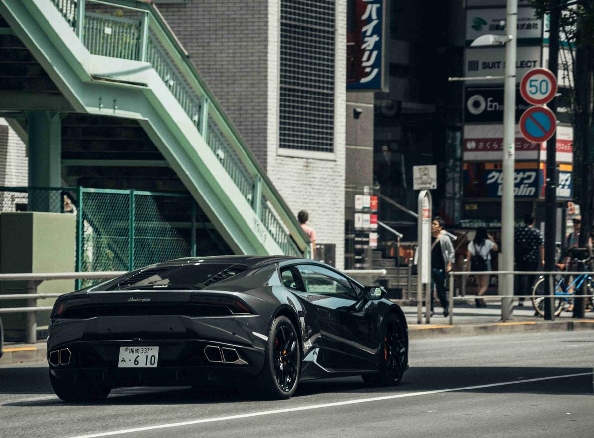 Sleek Black Supercar in Urban Setting