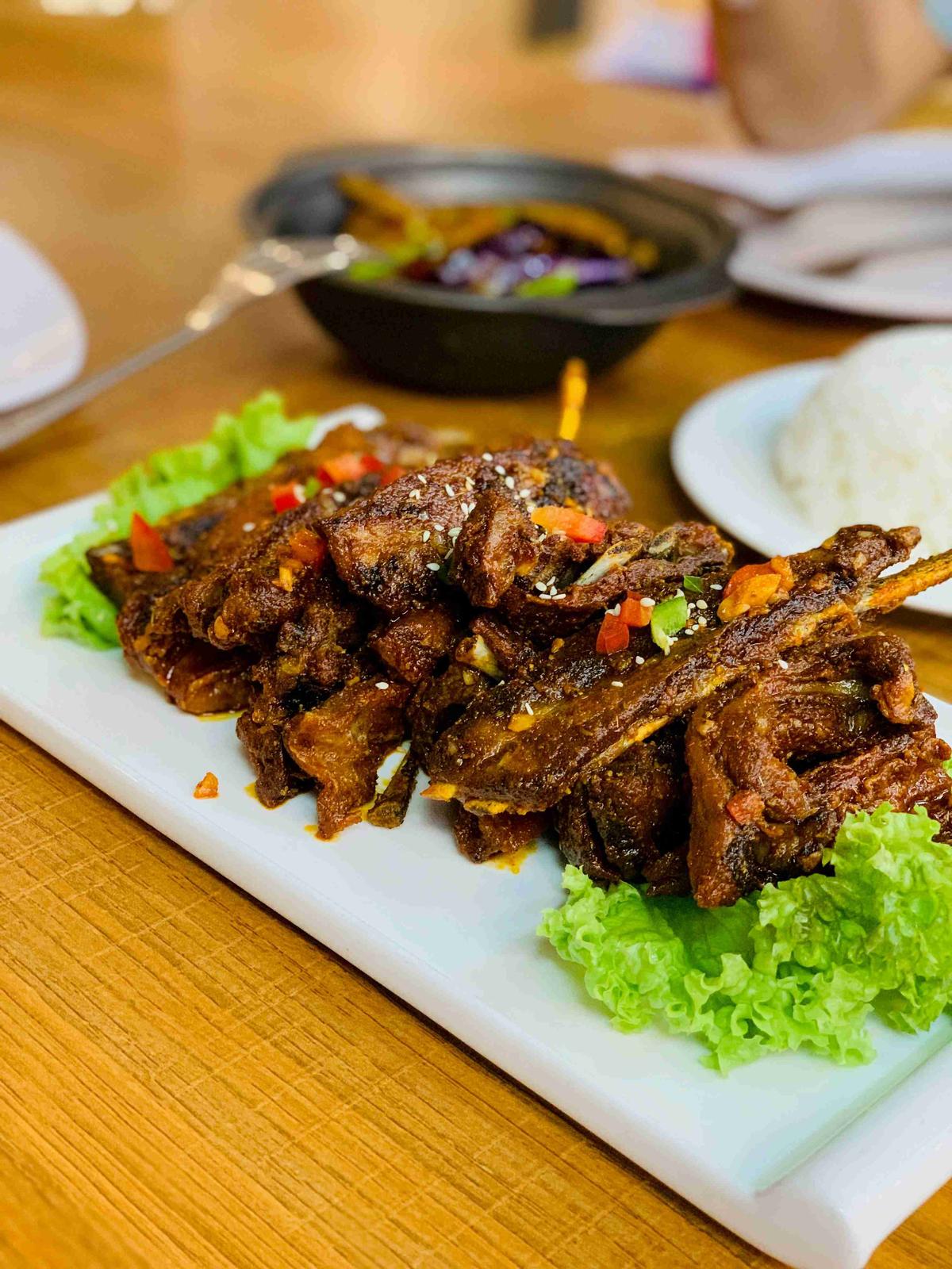Spicy Grilled Chicken Wings on White Plate Restaurant Setting