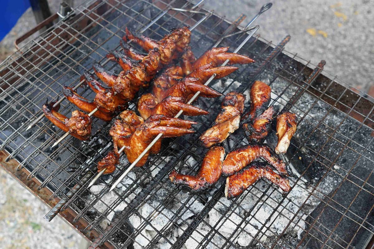 Street Food Grilled Chicken Wings and Drumstick on Barbecue