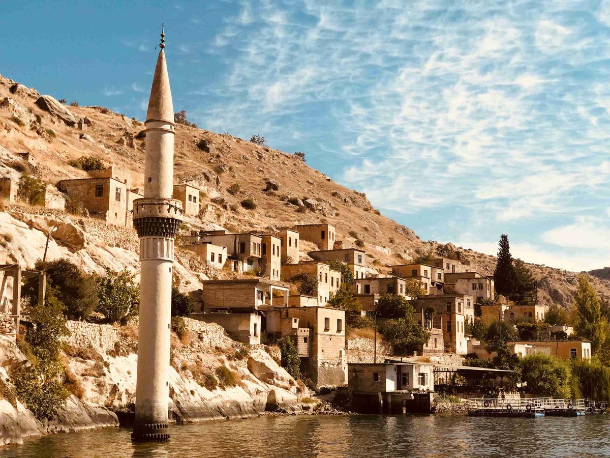 Sunlit Old Town with Minaret by the River