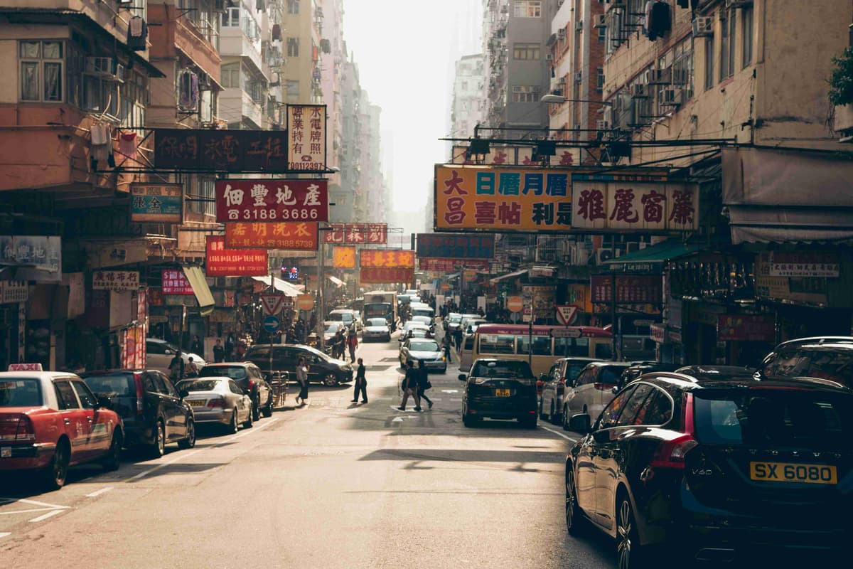 Sunlit Urban Street with Traditional Signboards in Hong Kong