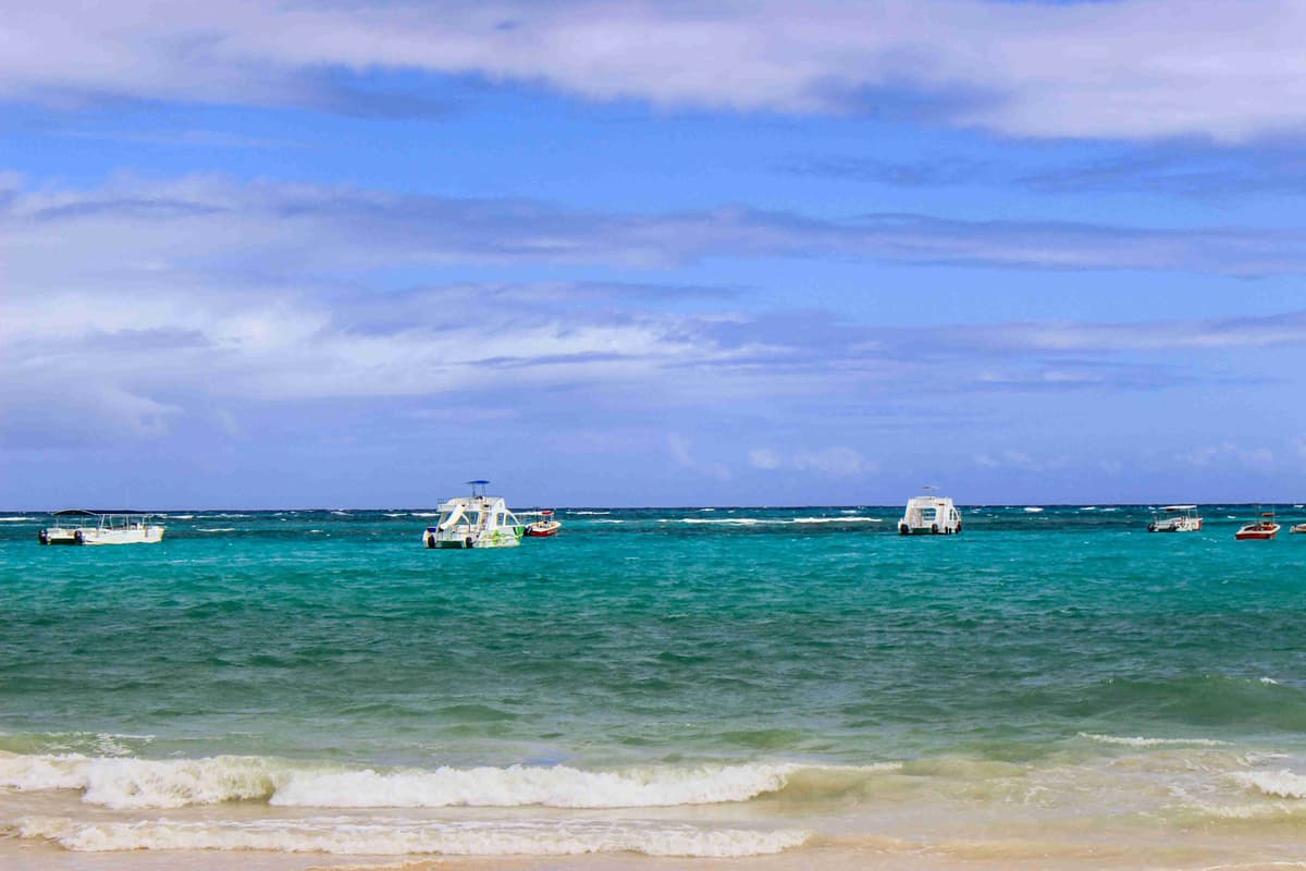 Turquoise Waters and Boats on Tropical Beach