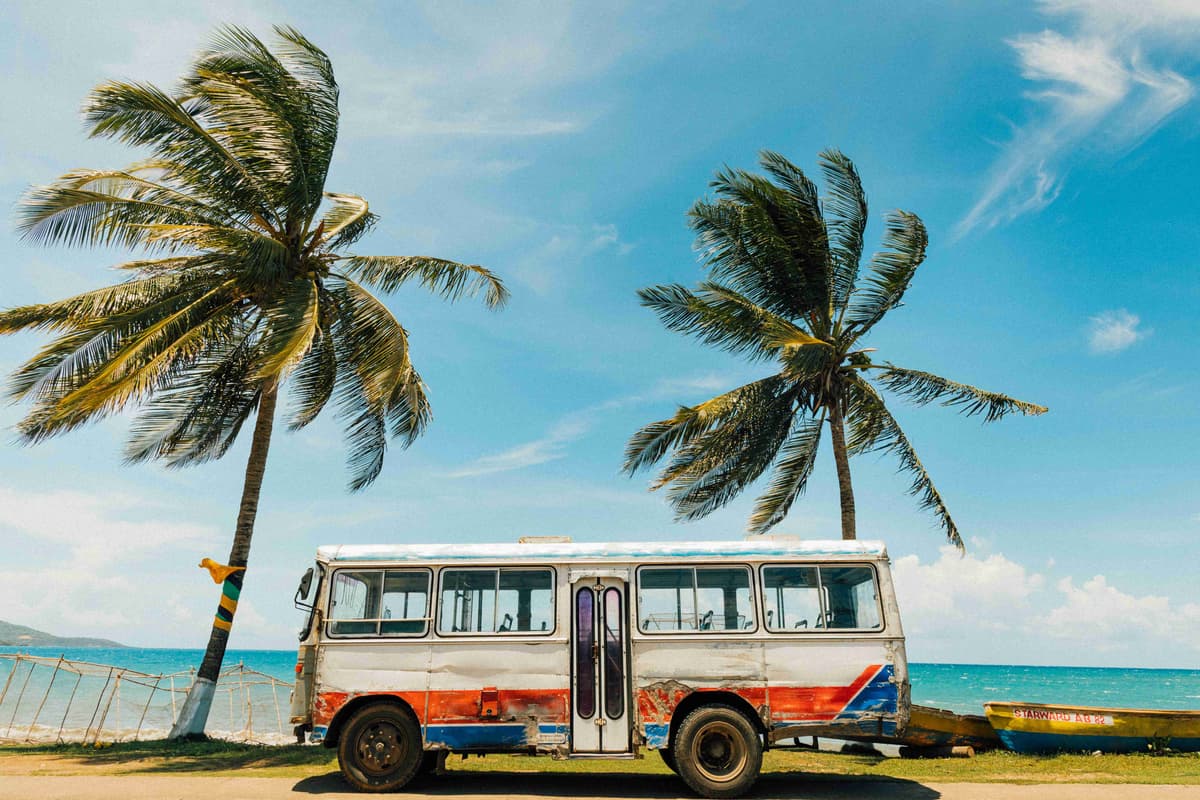 Vintage Bus by Tropical Beach with Palms