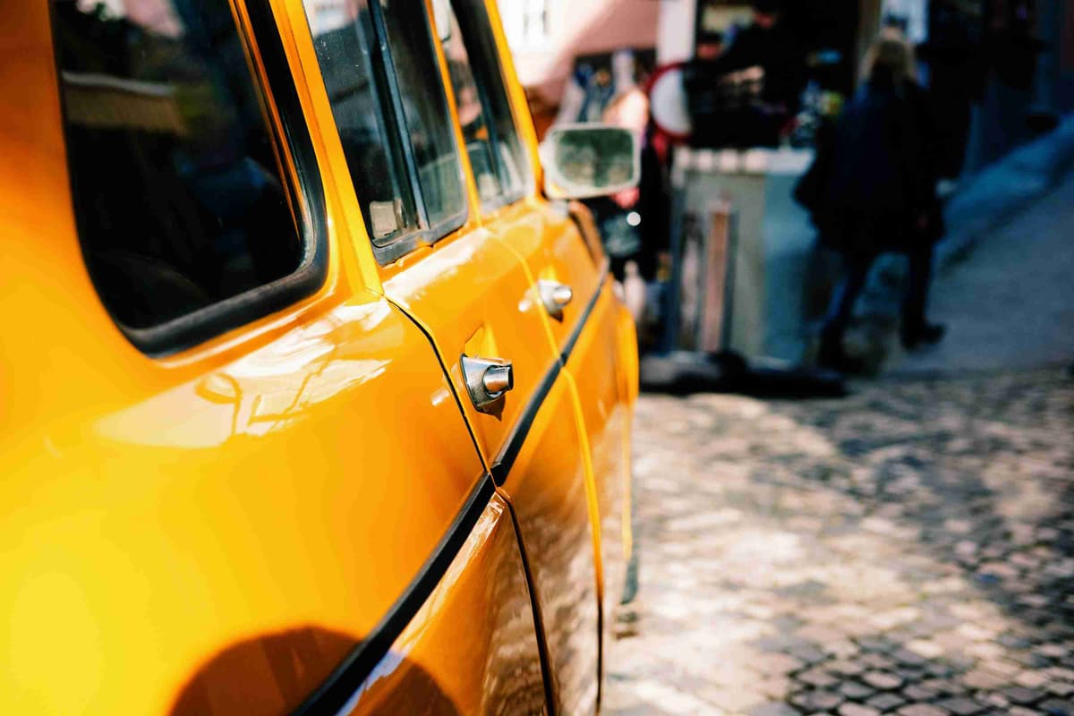 Vintage Yellow Car Closeup on Cobbled Street