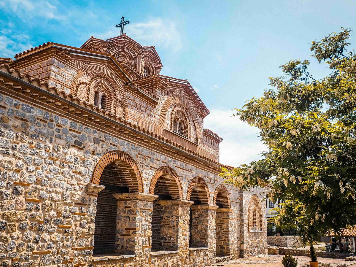 a-stone-building-with-a-cross-on-top-of-it