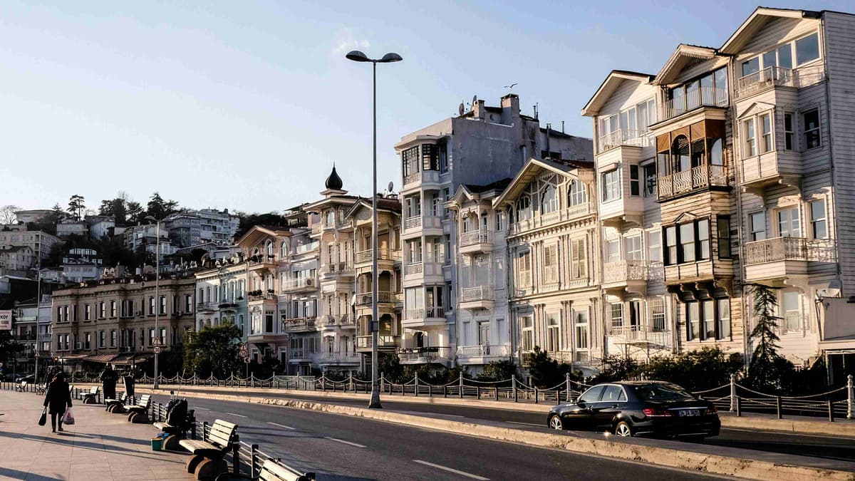 black car parked beside white concrete building