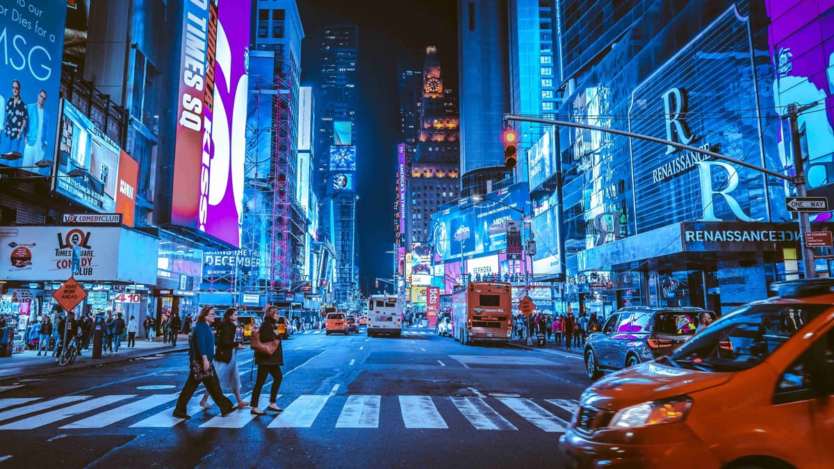 people-walking-on-pedestrian-lane-during-night-time