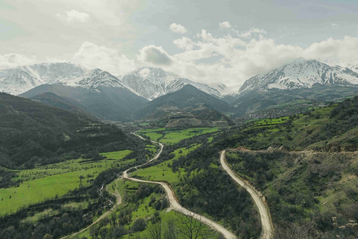 a-scenic-view-of-a-winding-road-in-the-mountains