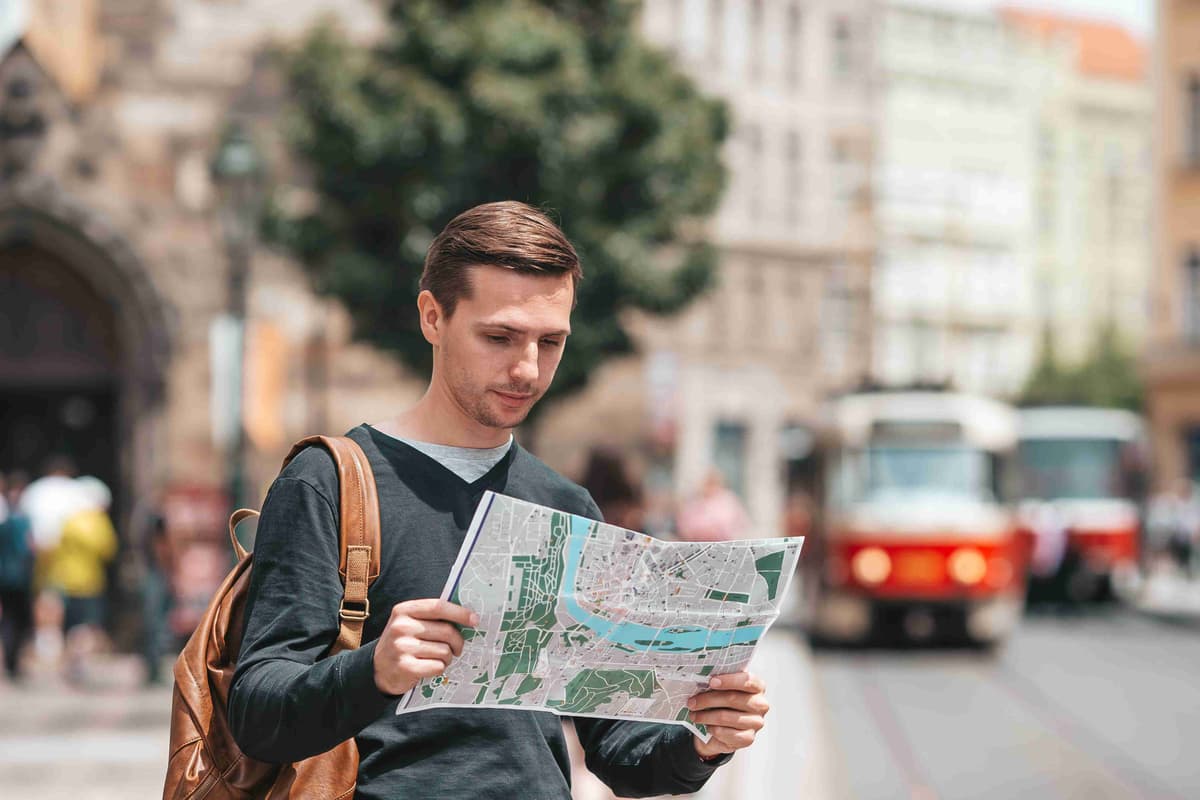 carefree-young-man-searching-for-place-of-destination