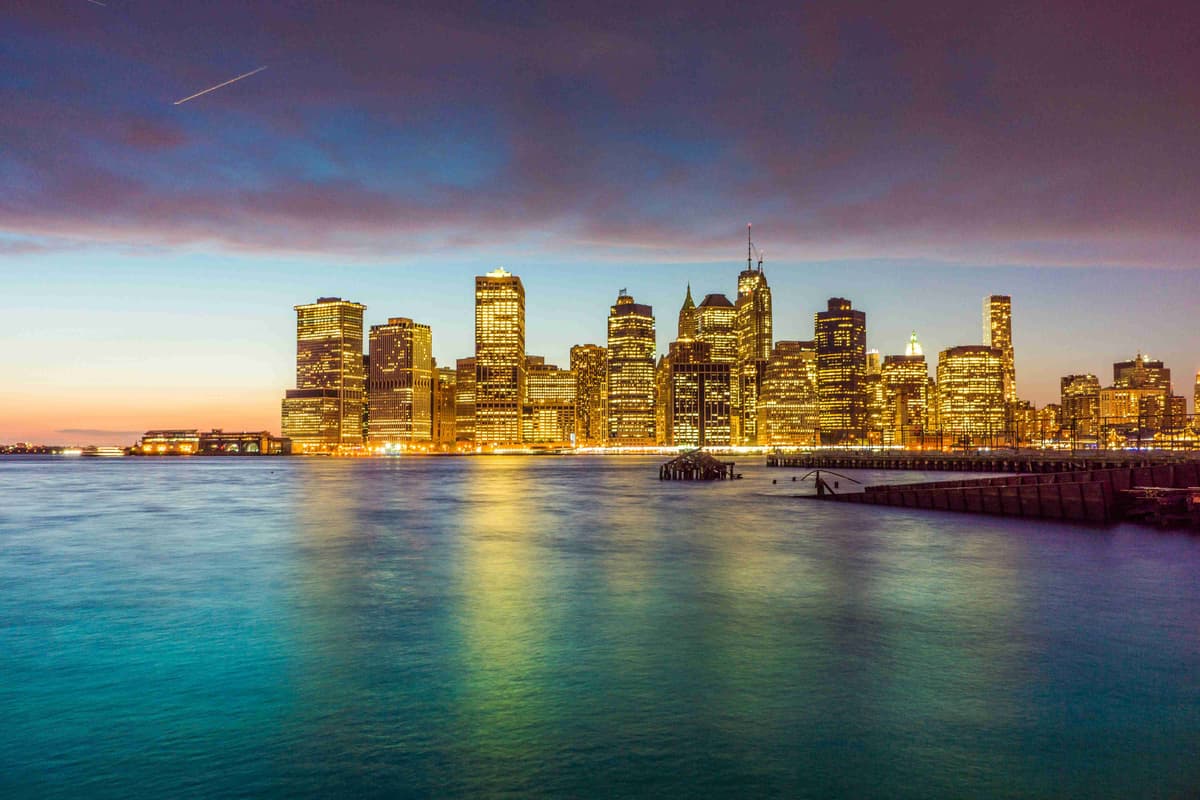 skyline della città attraverso lo specchio d'acqua durante la notte