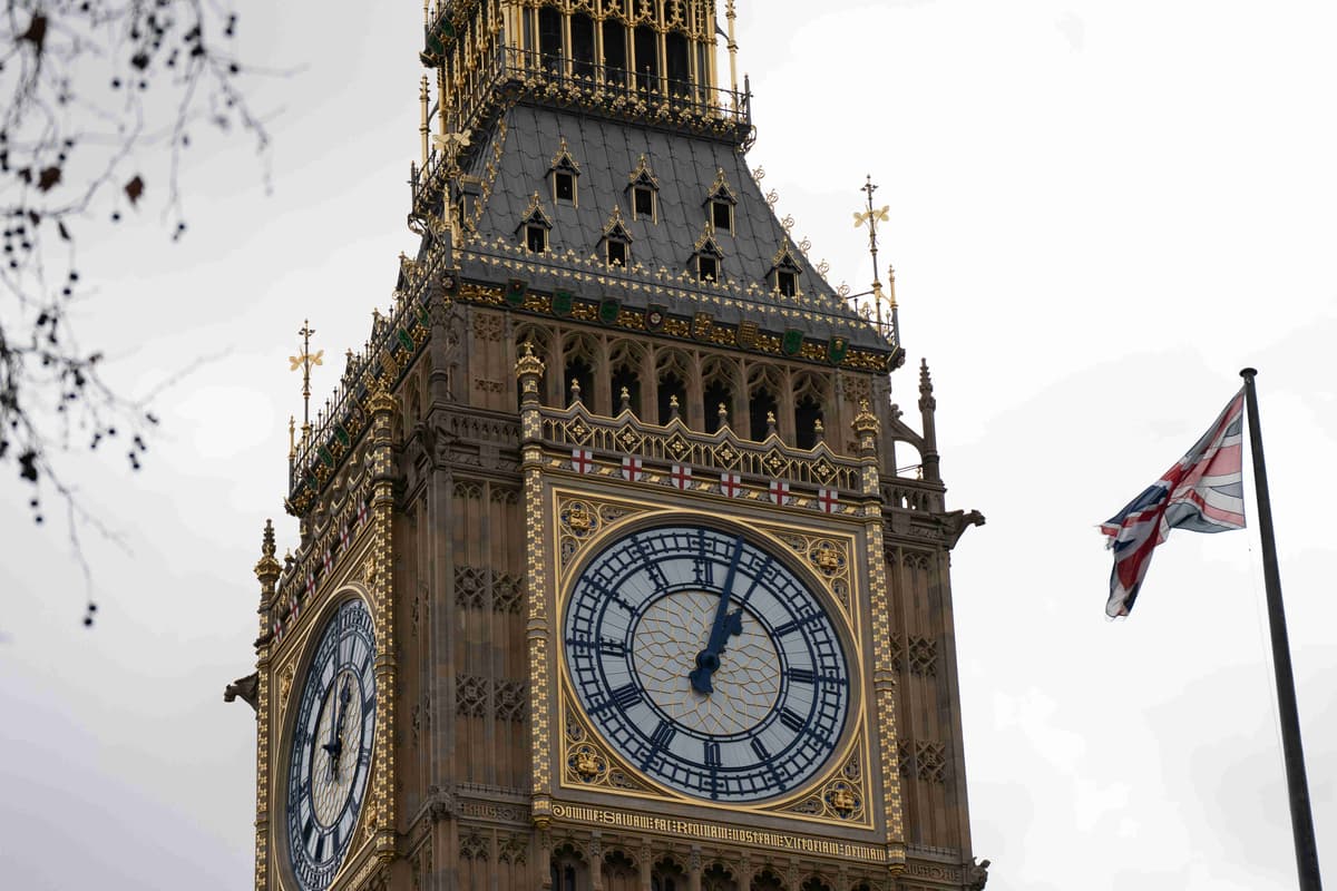 a-clock-tower-with-a-british-flag-flying-in-the-background