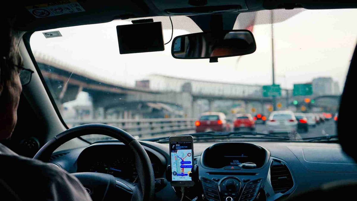 Driver's view with GPS navigation in city traffic.