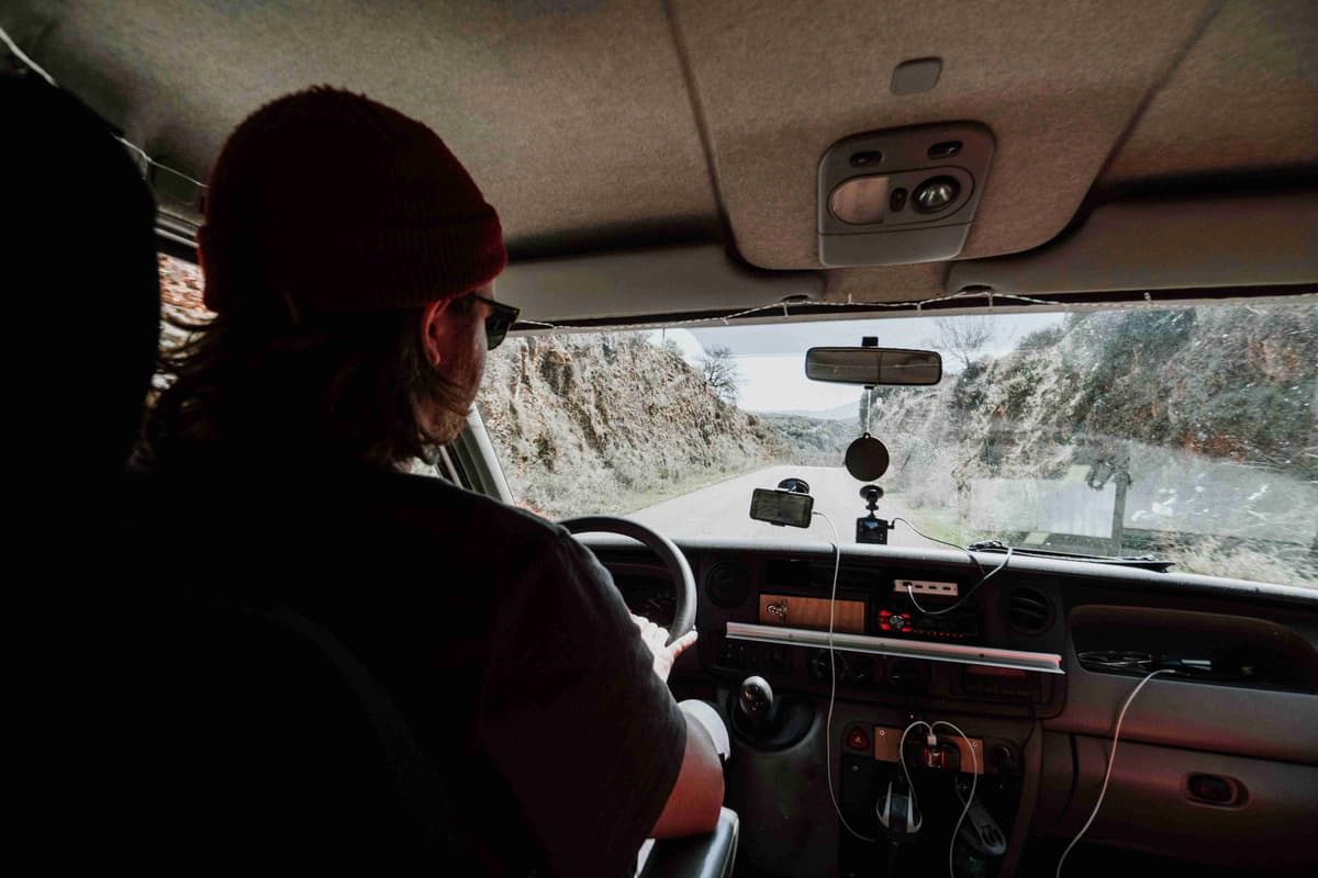a-woman-driving-a-car-on-a-mountain-road