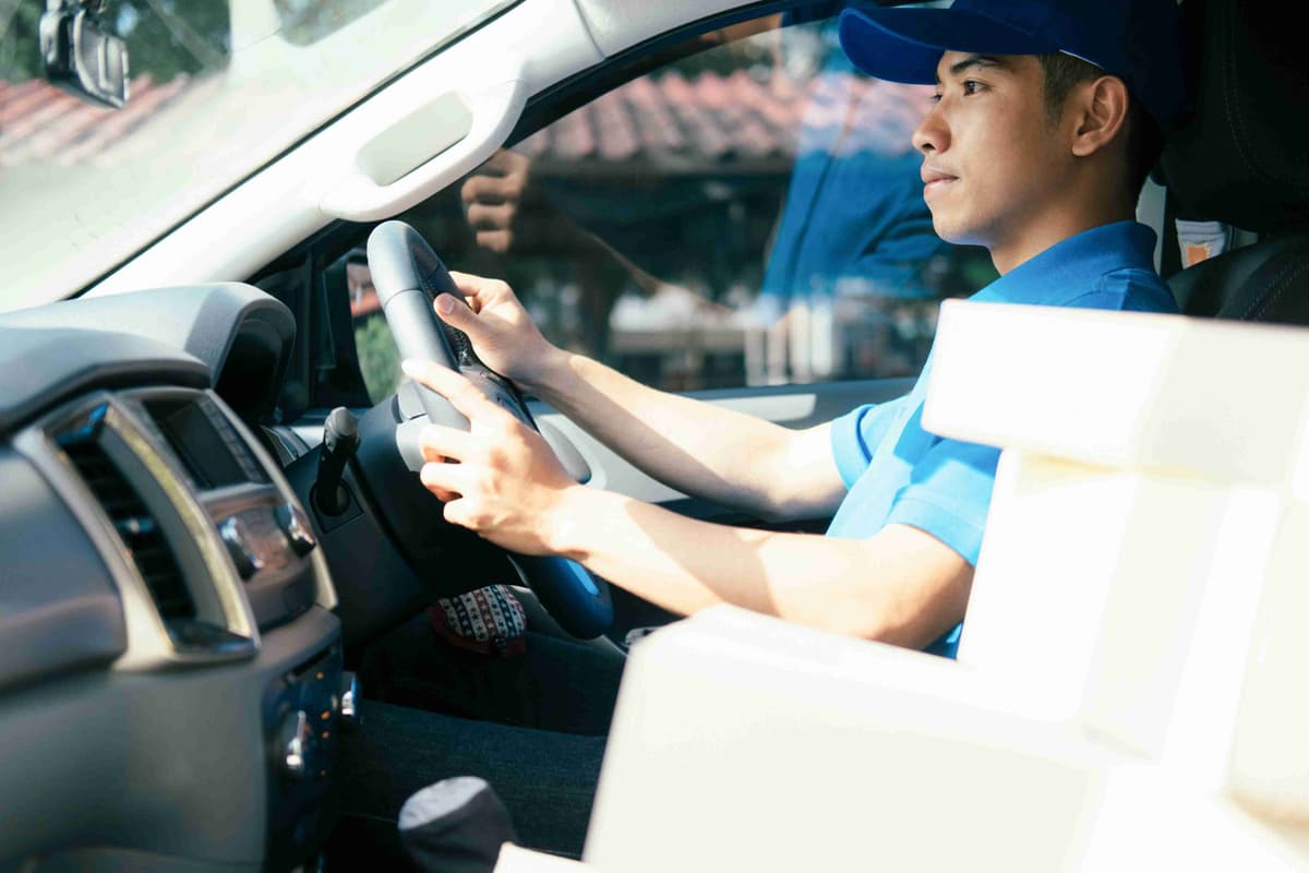 delivery-driver-driving-car-with-package