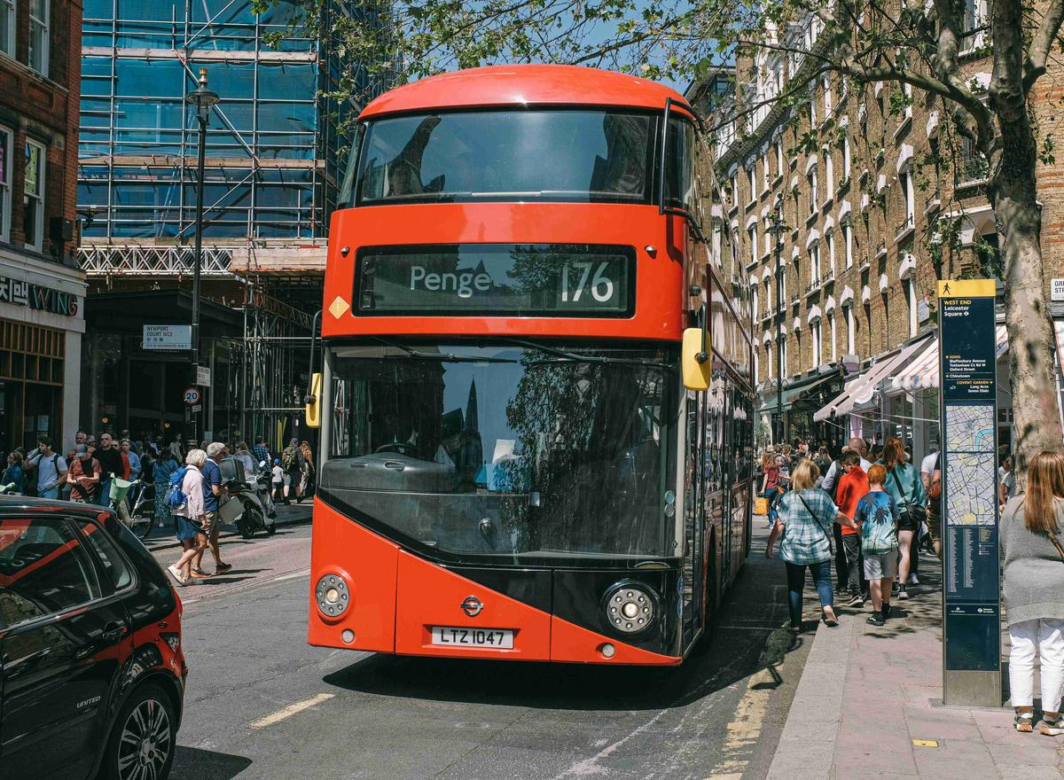 a-red-double-decker-bus-driving-down-a-street
