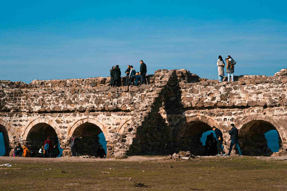 a-group-of-people-standing-on-a-stone-structure