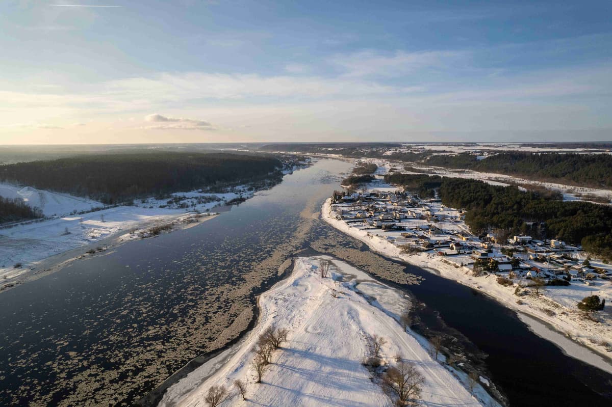 a-river-running-through-a-snow-covered-countryside