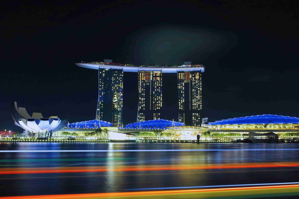Nighttime view of Marina Bay Sands in Singapore with illuminated skyline.