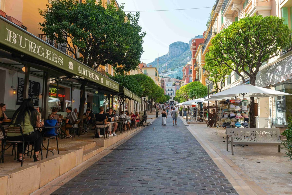 a cobblestone street lined with shops and restaurants