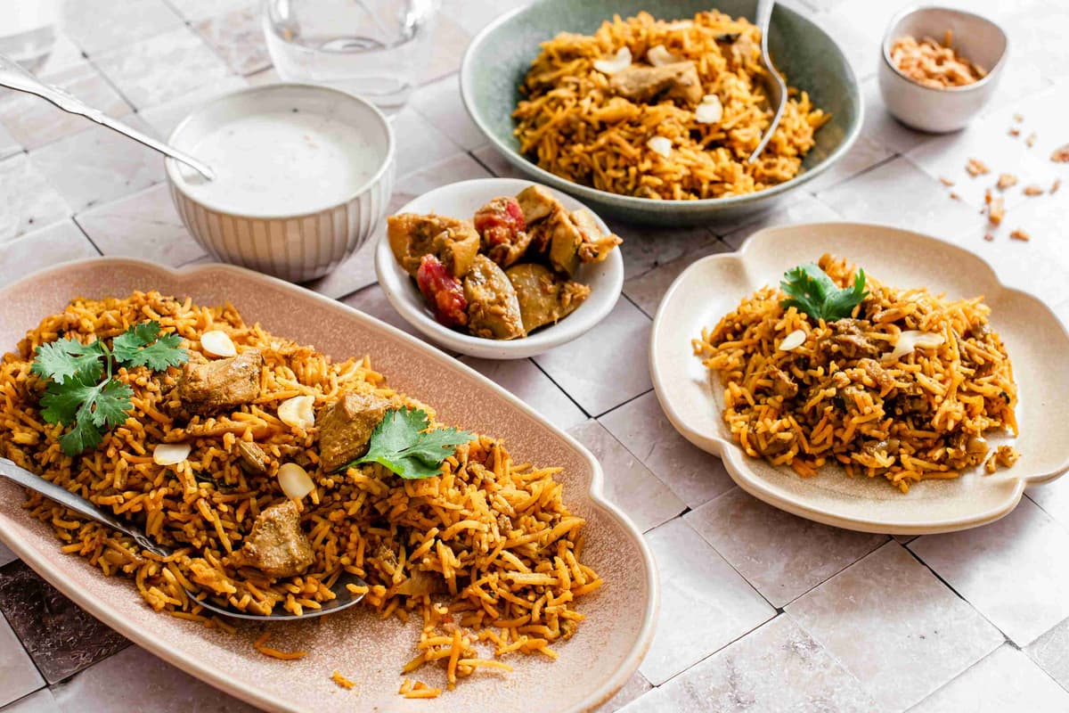 a-table-topped-with-plates-of-food-and-bowls-of-rice