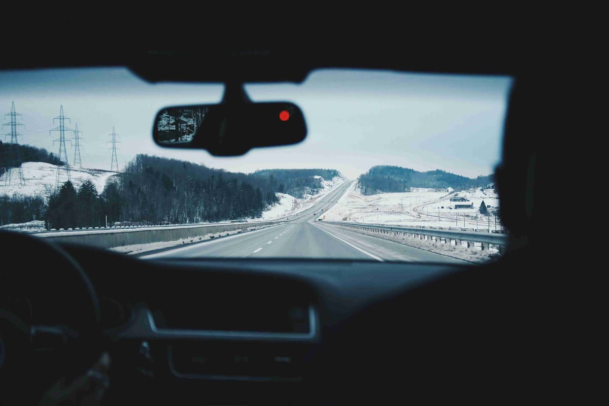 two-people-inside-of-car-while-driving-on-asphalt-road