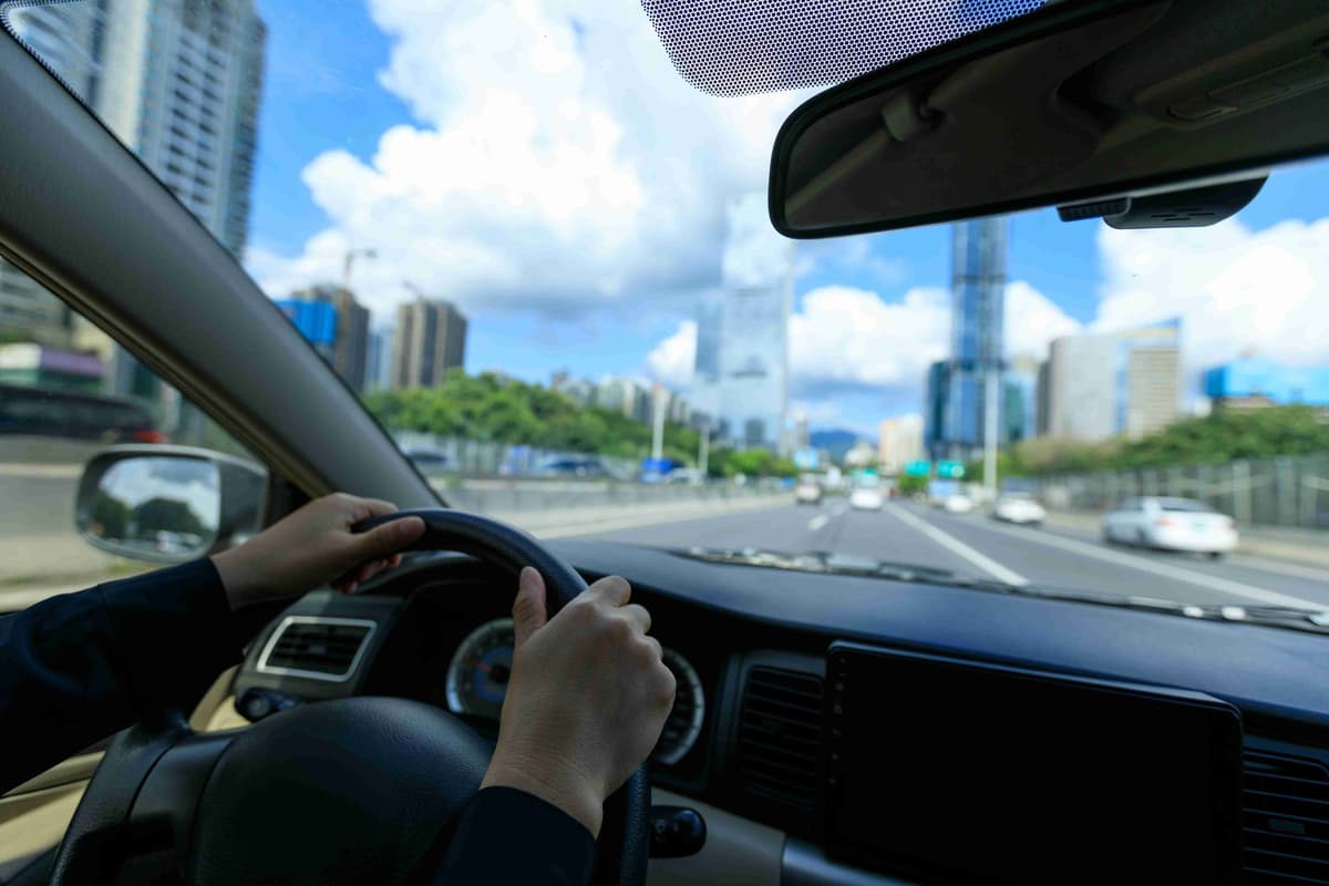 People driving car on city road
