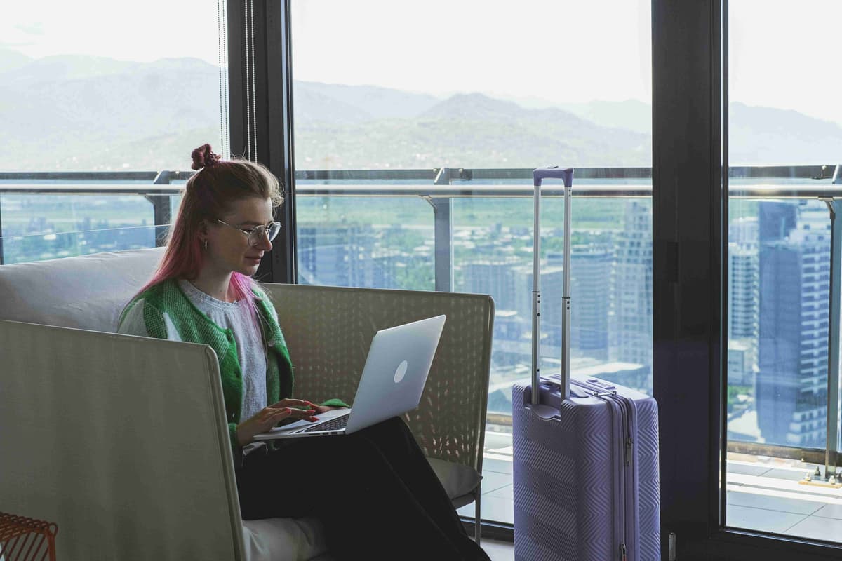a woman sitting on the sofa using a laptop