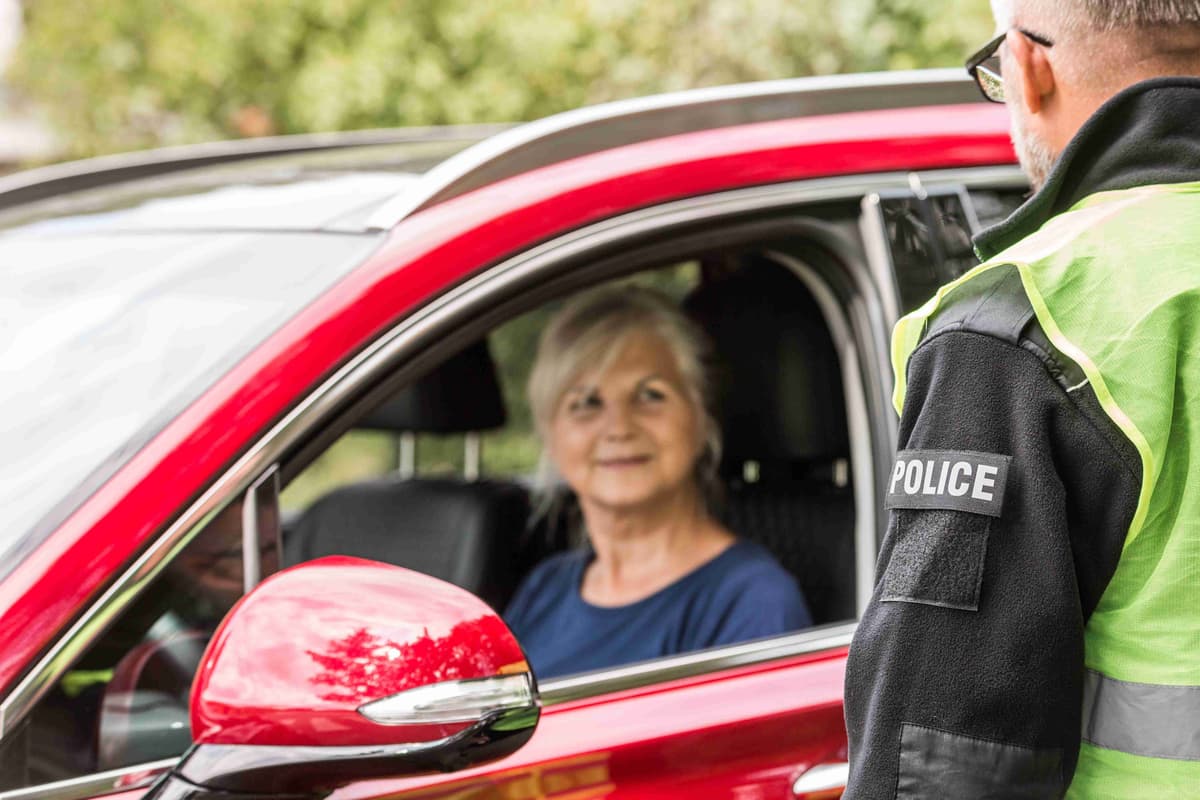 policeman-talks-to-an-elderly-lady-sitting