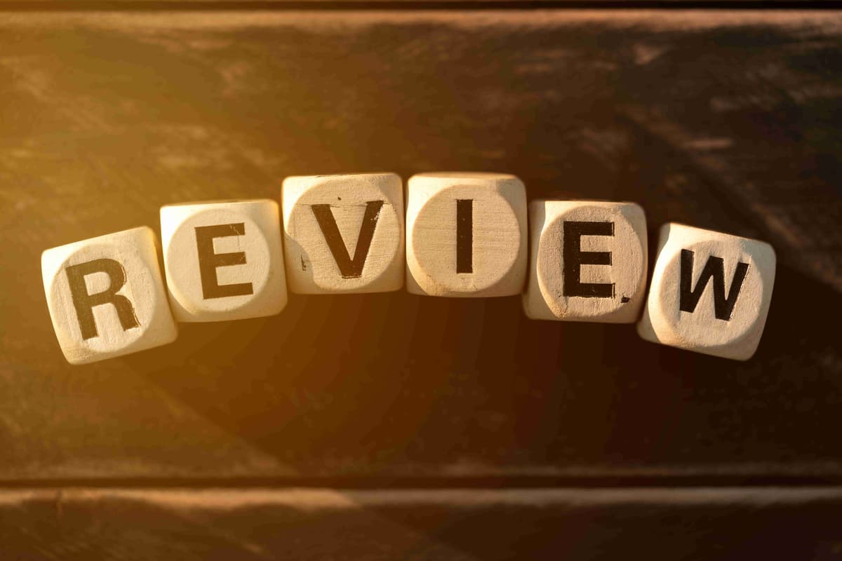 Review concept with wooden block on wooden table