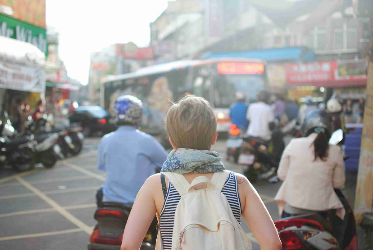 นักเดินทางสำรวจถนนในเมืองที่พลุกพล่าน