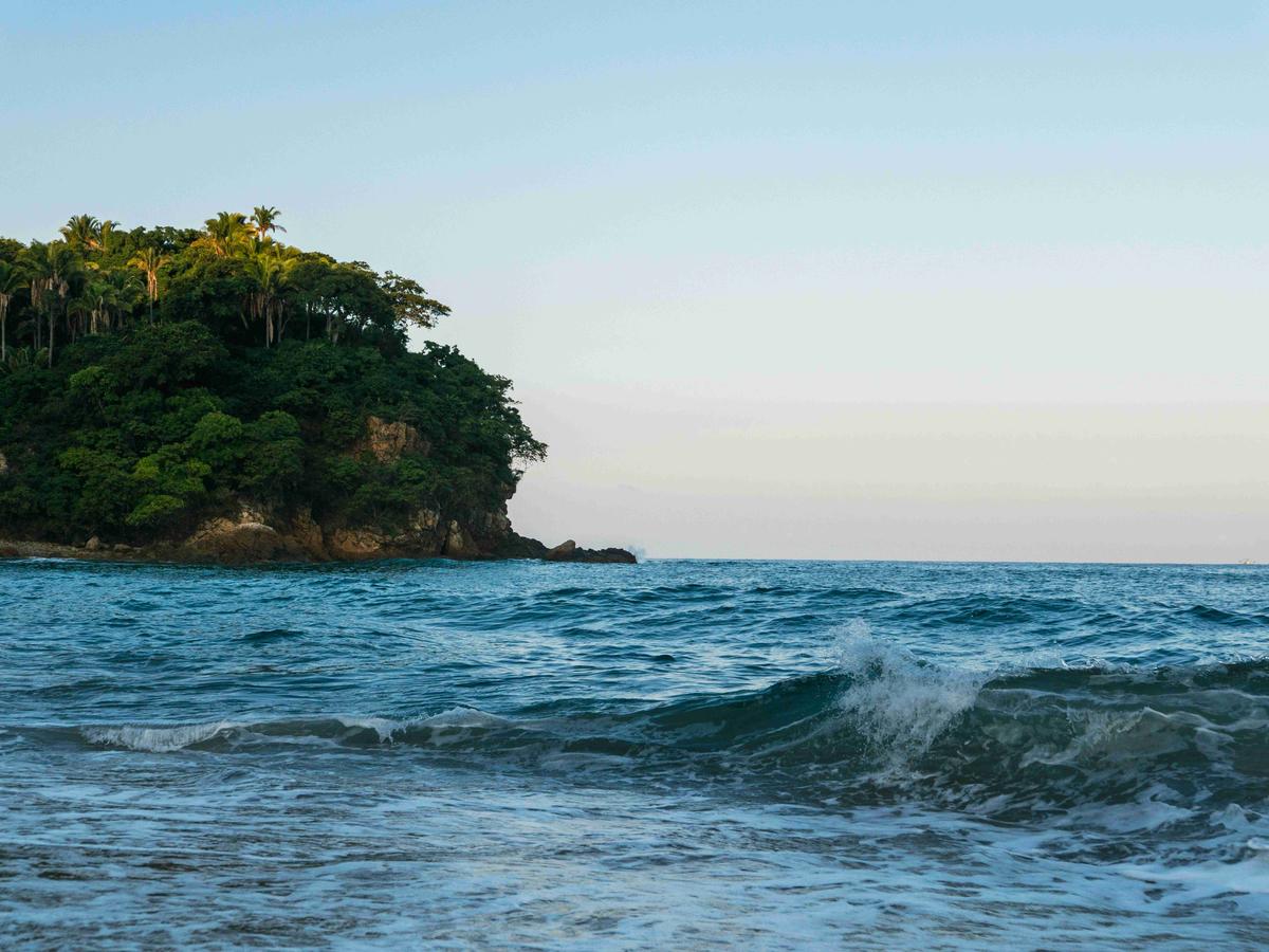 a-body-of-water-with-trees-on-the-side