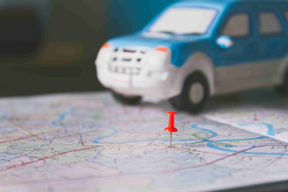 Toy car and push pin on the map