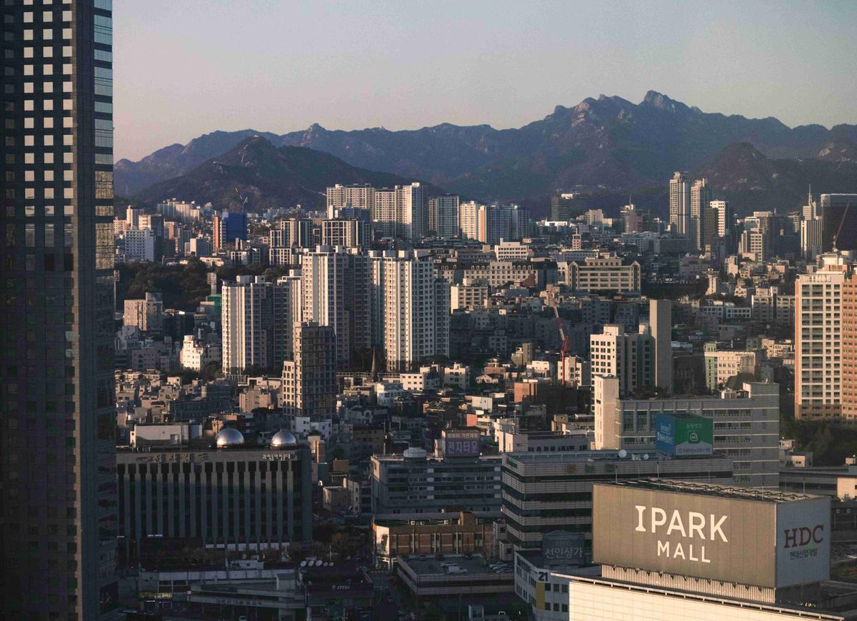 a-view-of-a-city-with-mountains-in-the-background